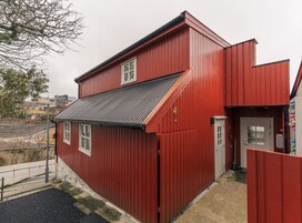 A red building with a sloped roof and a small window.