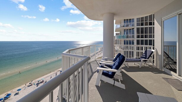 A balcony with a view of the beach and ocean, white railings, and two blue lounge chairs. - Island Royale 506 Penthouse by Liquid Life (Gulf Shores)