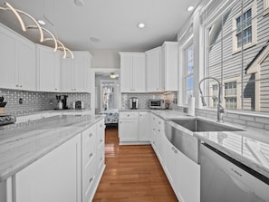 Kitchen features a Bosch dishwasher, sink, and stainless steel faucet, with a window and ceiling fan.