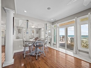 Enjoy meals with a view of the ocean from this dining area with a large table and comfortable seating.