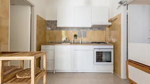 A modern kitchen with white cabinets, a stove, and a dishwasher. - 3490 Villetta Boschetto by Barbarhouse (Maruggio)