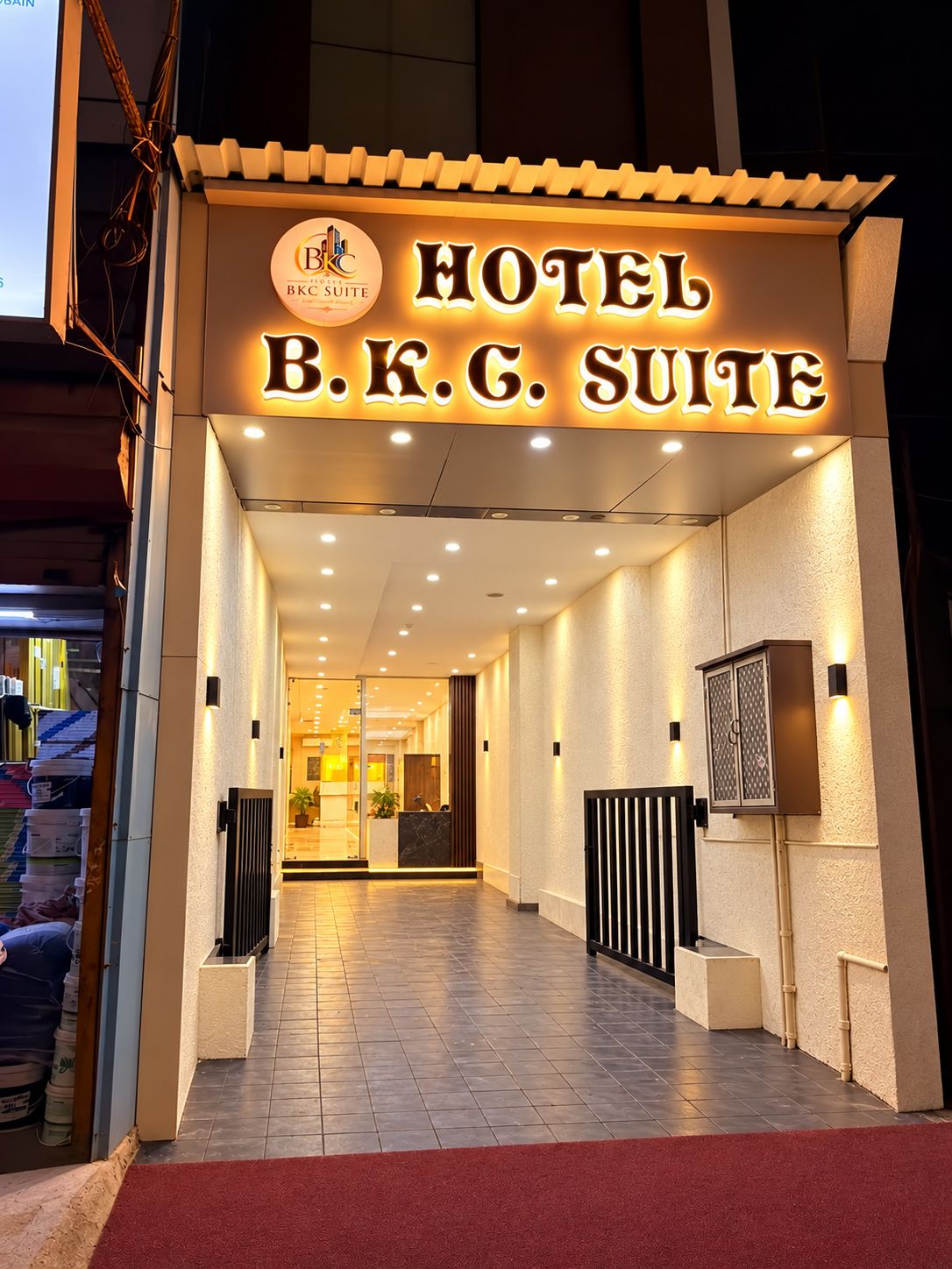 The entrance to a hotel with a sign reading 'HOTEL B.K.G. SUITE'.