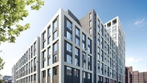 A modern multi-story building with a grid of windows and a flat roof. - 2-bed Luxury Apartment in Birmingham City Center (Birmingham)