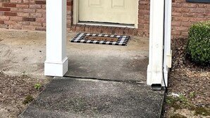 A beige door with a number '2' above it, set in a brick wall with a small overhang above. - AU Condo Getaway Across From Vet School - Kitchen, Pools, Queen BR, Pets Welcome (Auburn)