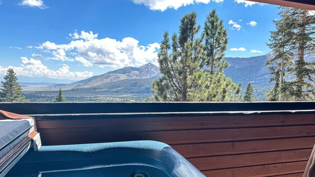 A hot tub with a mountain view. - Bridges #108 2 Bedroom Condo by RedAwning (Mammoth Lakes)