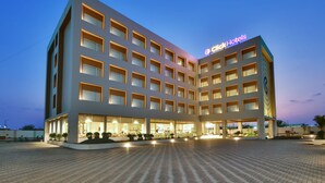 A multi-story hotel with a modern design, featuring a prominent 'Click Hotels' sign. - Click Hotel Pithampur (Dr. Ambedkar Nagar)