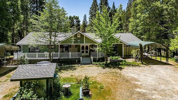 A two-story house with a porch, surrounded by a forest. - Let our place be the basecamp for your exploration at Yosemite! (Mariposa)