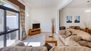 A living room with a sofa, TV, and a coffee table. - Hgieri - Ghasri Holiday Home (L-Għasri)