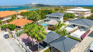 Ein Resort mit mehreren Gebäuden, einem Swimmingpool und Blick auf den Ozean.