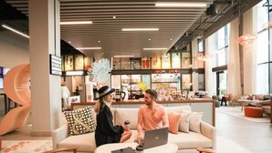 A modern interior with a sofa and a table, a laptop, and a coffee cup. - King Room Near Civil Defance Downtown by E R (Dubai)