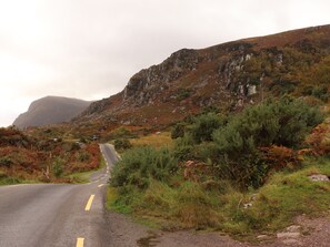 A winding road in a mountainous area with rocky terrain and sparse vegetation. - ROWANTREE, family friendly, with open fire in Beaufort, County Kerry (Beaufort, Killarney)
