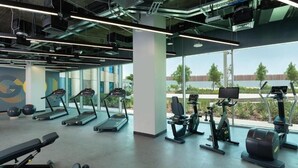A modern gym with treadmills, elliptical machines, and free weights. - King Room Near Expo 2020 by ER (Dubai)