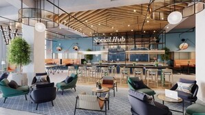 A modern lounge area with seating arrangements, a bar, and a visible sign reading "Social Hub". - King Room Near Expo 2020 by ER (Dubai)