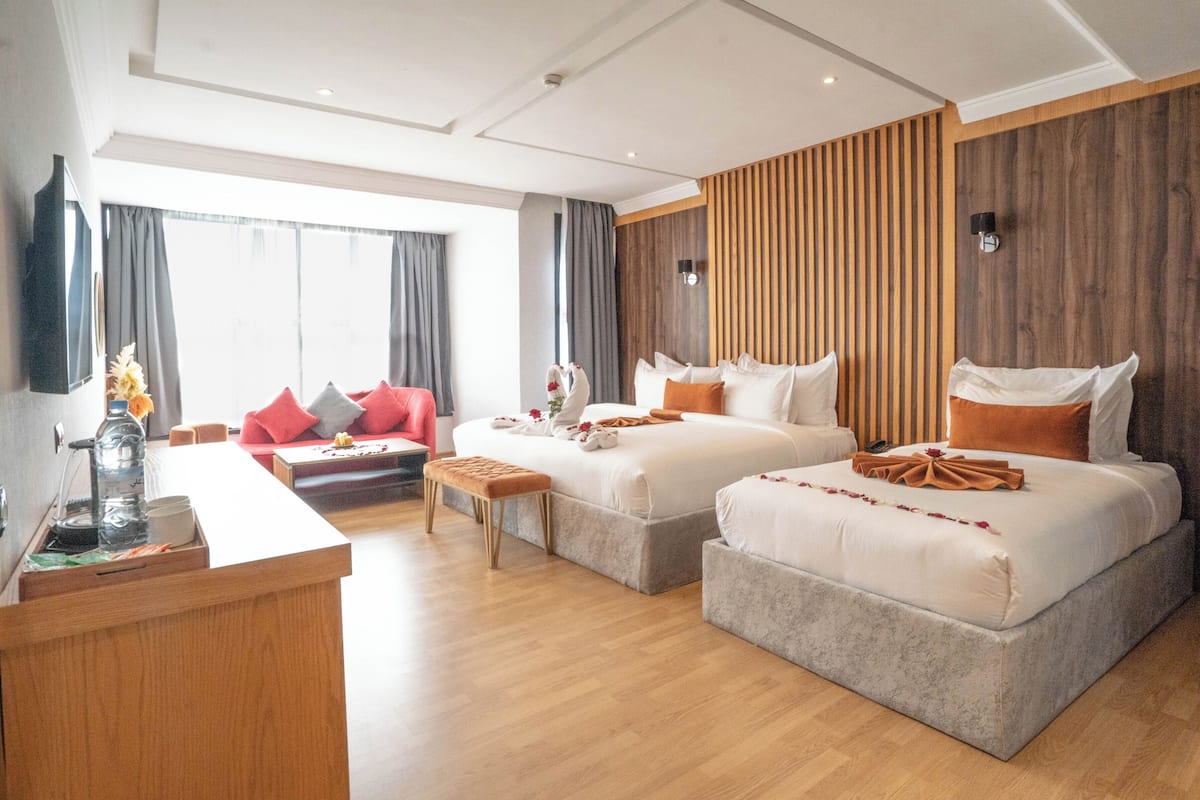 Grand Suite | Living area | 32-inch flat-screen TV with satellite channels