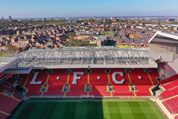 A stadium with red seating and the letters "LFC" visible.