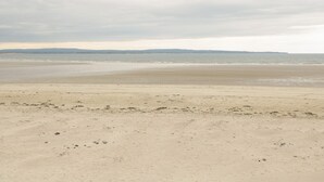 A beach with a wide sandy shore and calm water. - CHURCHFIELD HOUSE, pet friendly in Crossmolina, County Mayo (Ballina)
