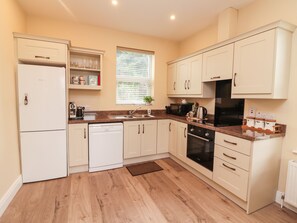 Oppvaskmaskin, høy barnestol og kjøkkenutstyr