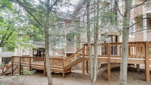 A wooden deck with a staircase leading to a building. - All-season Fun! Wintergreen Resort Condo w/ Views (Nellysford)