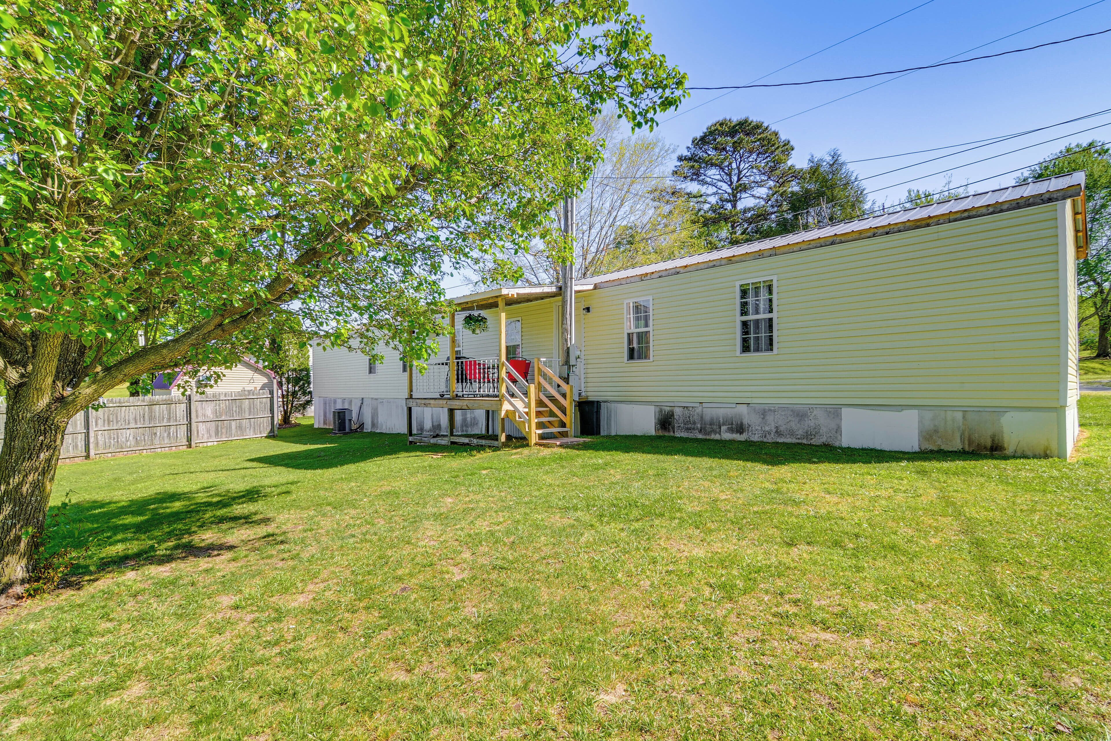 A single-story house with a covered porch and a small staircase leading to the entrance.
