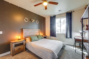 A bedroom with a bed, bedside tables, a desk, and a ceiling fan. - Spacious Retreat < 3 Mi to Downtown Flagstaff! (Flagstaff)