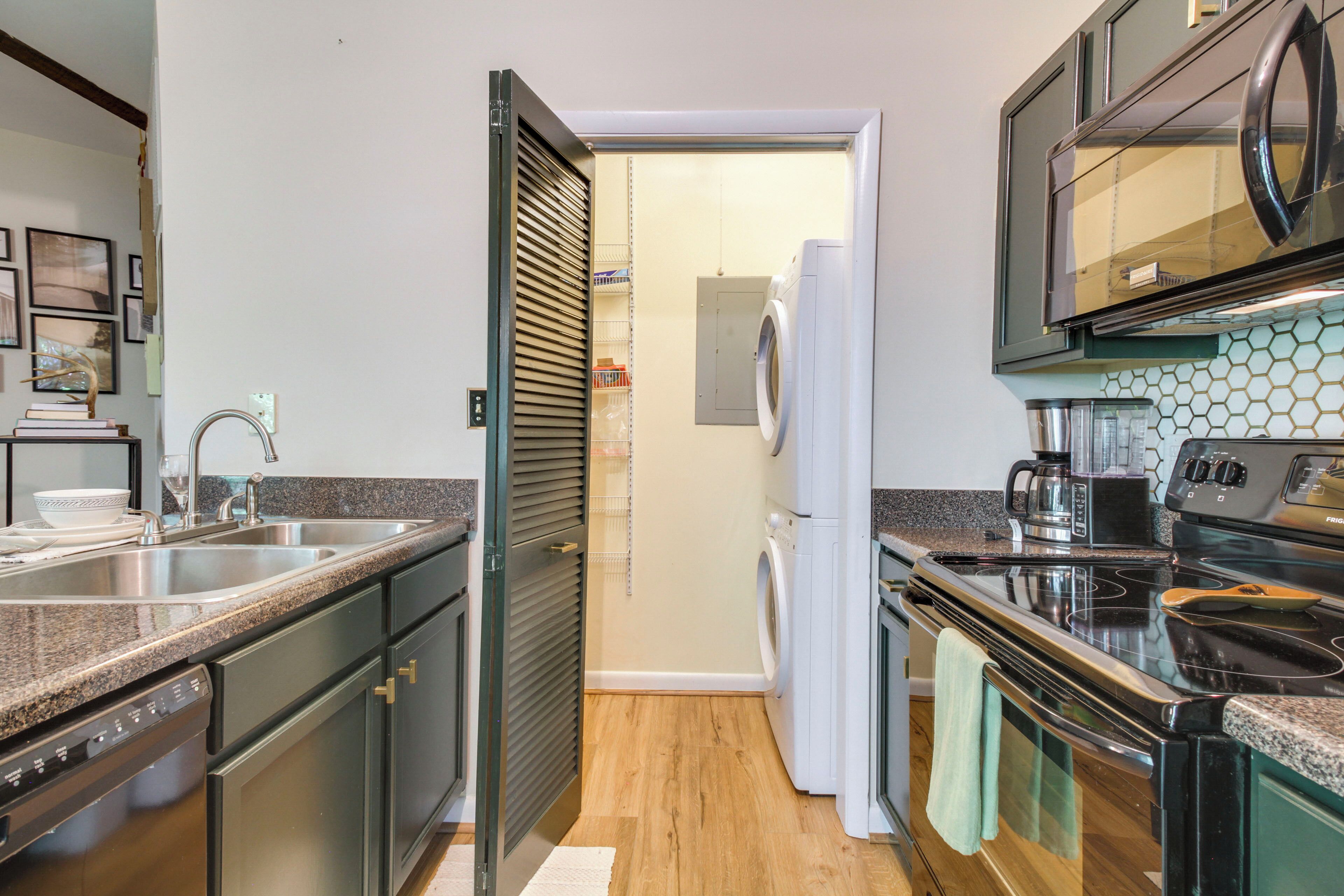 A modern kitchen with stainless steel appliances, a dishwasher, and a microwave.