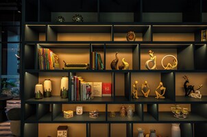 A modern bookshelf with various decorative items and books.