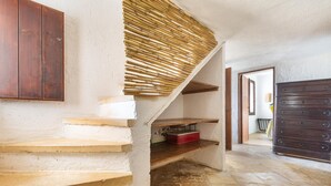 A staircase with a bamboo blind, a wooden cabinet, and a dresser. - 3503 PJE - Casa La Pergola by Barbarhouse (Castrignano del Capo)