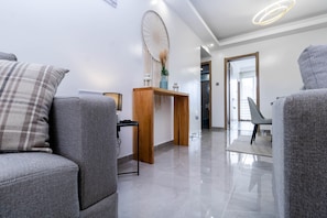 Relax in this stylish living space with a sofa, armchair, and console table.