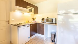 Una cocina compacta equipada con lavavajillas, microondas y refrigerador.