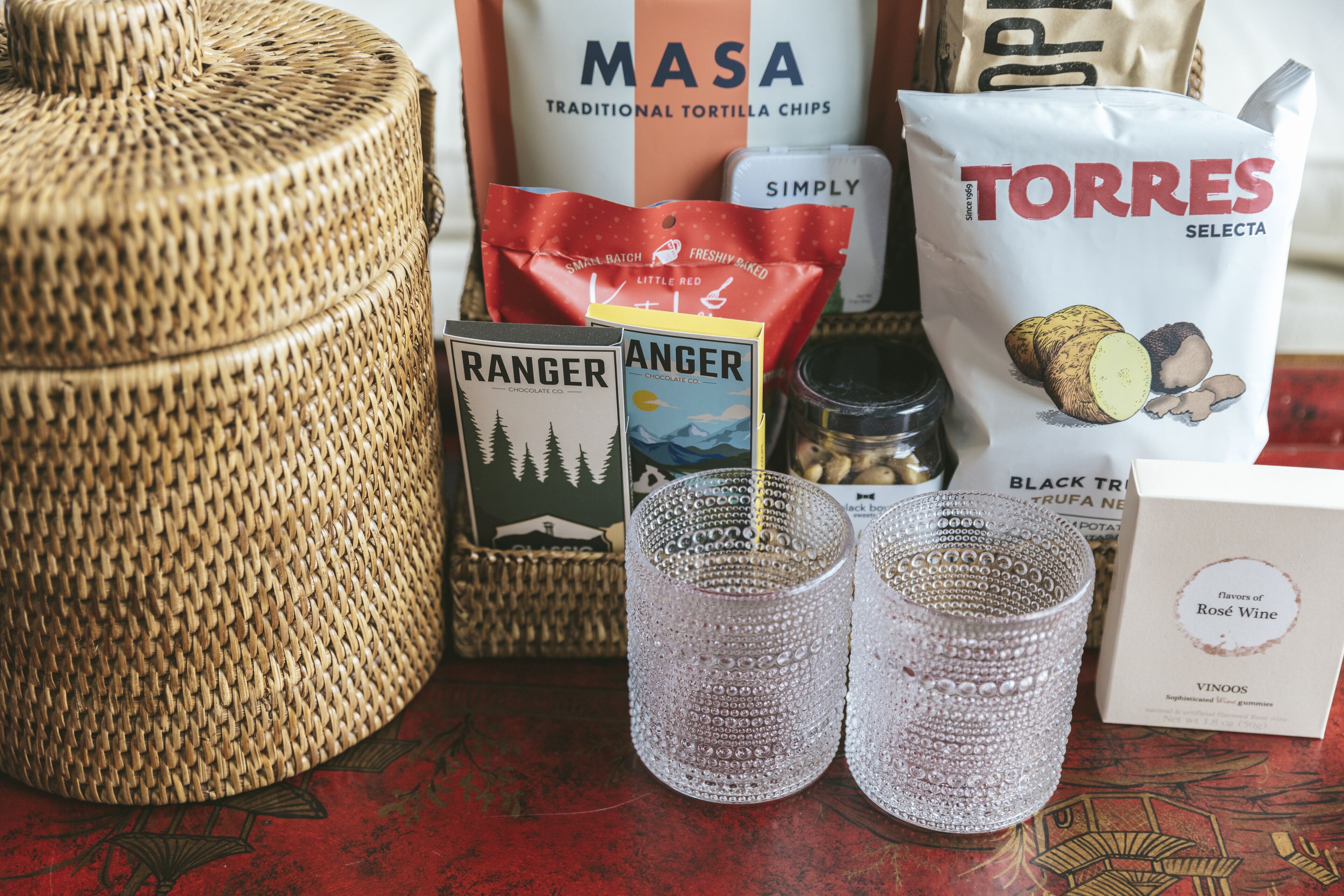 A table with various food items, including bags of chips and a book titled "RANGER".
