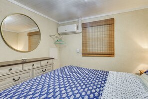A bedroom with a bed, a dresser, a mirror, an air conditioner, and a window with blinds. - 2 Blocks to Sand! Breezy Atlantic Beach Escape (Myrtle Beach)