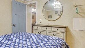 A bedroom with a bed, a dresser, a mirror, and a door. - 2 Blocks to Sand! Breezy Atlantic Beach Escape (Myrtle Beach)
