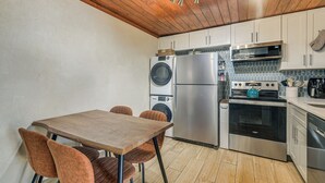 A compact kitchen with a wooden ceiling, a washing machine, a refrigerator, a microwave, and a stove. - 2 Blocks to Sand! Breezy Atlantic Beach Escape (Myrtle Beach)