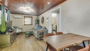 A cozy living area with a wooden ceiling, a sofa, a dining table, and a small side table. - 2 Blocks to Sand! Breezy Atlantic Beach Escape (Myrtle Beach)