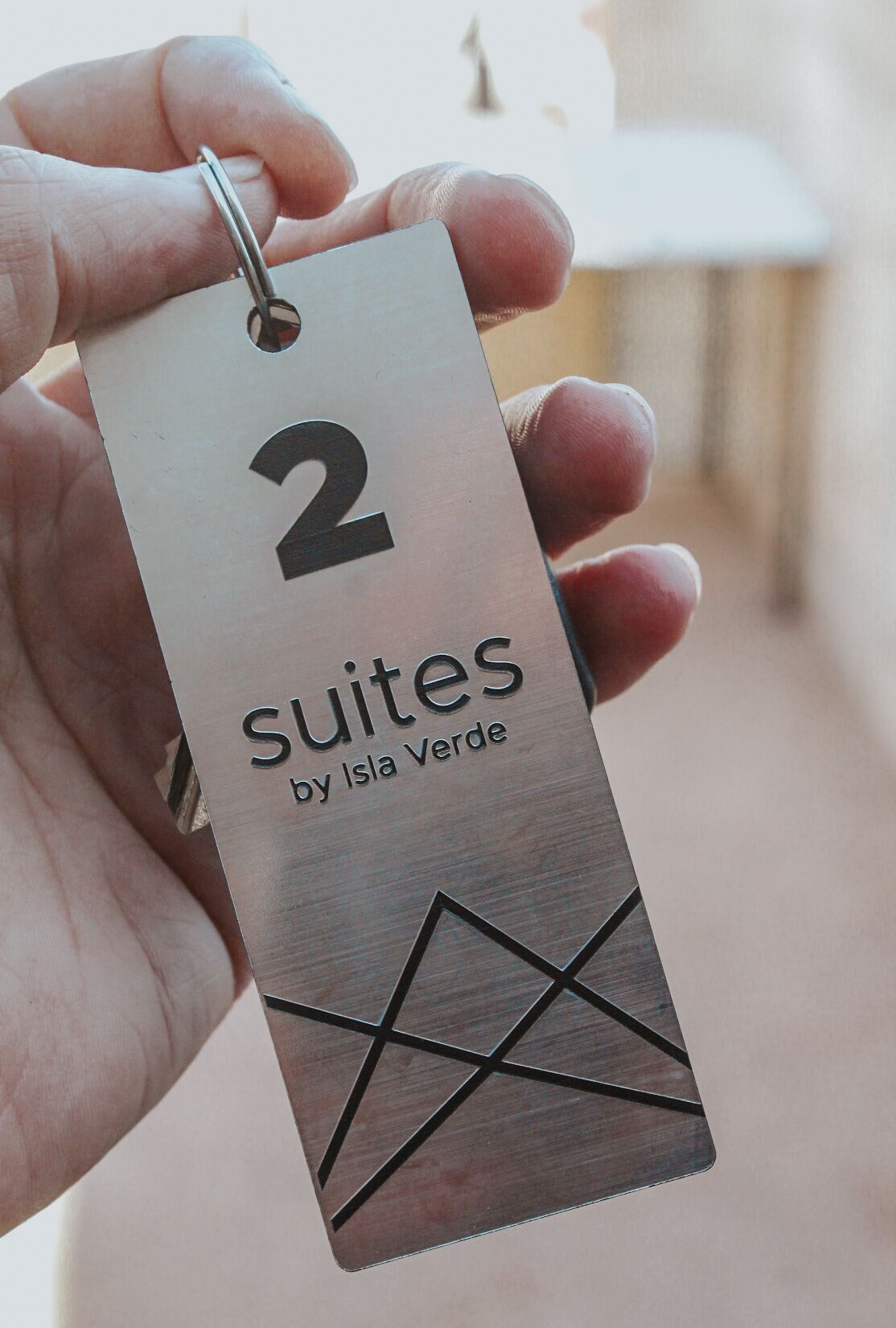 A tag with the number 2 and the text "Suites by Isla Verde".