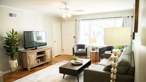 A living room with a television, sofa, coffee table, and a ceiling fan. - Newly Remodeled 3 Bdrm 2 Bath near Expo Sq, TU, and Downtown (Tulsa)