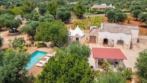 A villa with a swimming pool, surrounded by lush greenery and olive trees. - 3584 Trullo Kalia by Barbarhouse (San Michele Salentino)