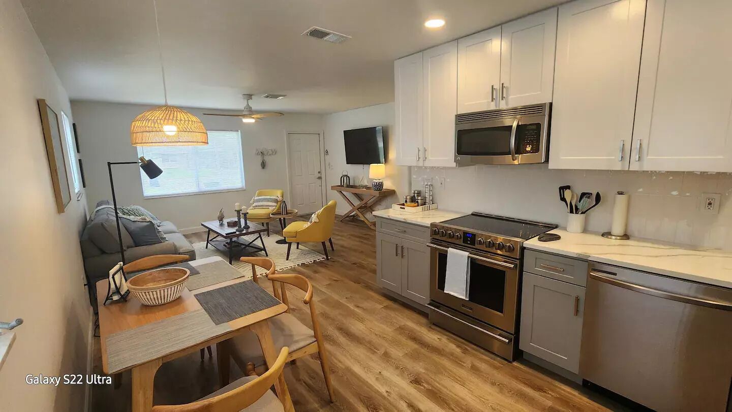 A compact kitchen with a microwave, stove, and modern appliances.
