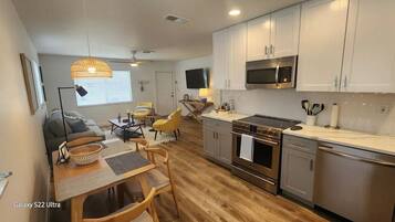 A compact kitchen with a microwave, stove, and modern appliances.