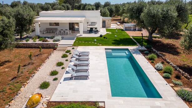 A modern house with a swimming pool, outdoor seating, and a well-maintained lawn. - 3419 Trullo Mest Marcucc by Perle di Puglia (San Michele Salentino)