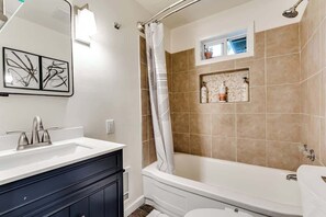 A bathroom with a bathtub, a shower, a sink, and a toilet. - Fir-Grove Retreat-Stylish Home in Tranquil Setting (Eugene)