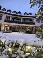 A hotel with a cafe named "CAFE MONA" and a restaurant named "PENSION MONA".