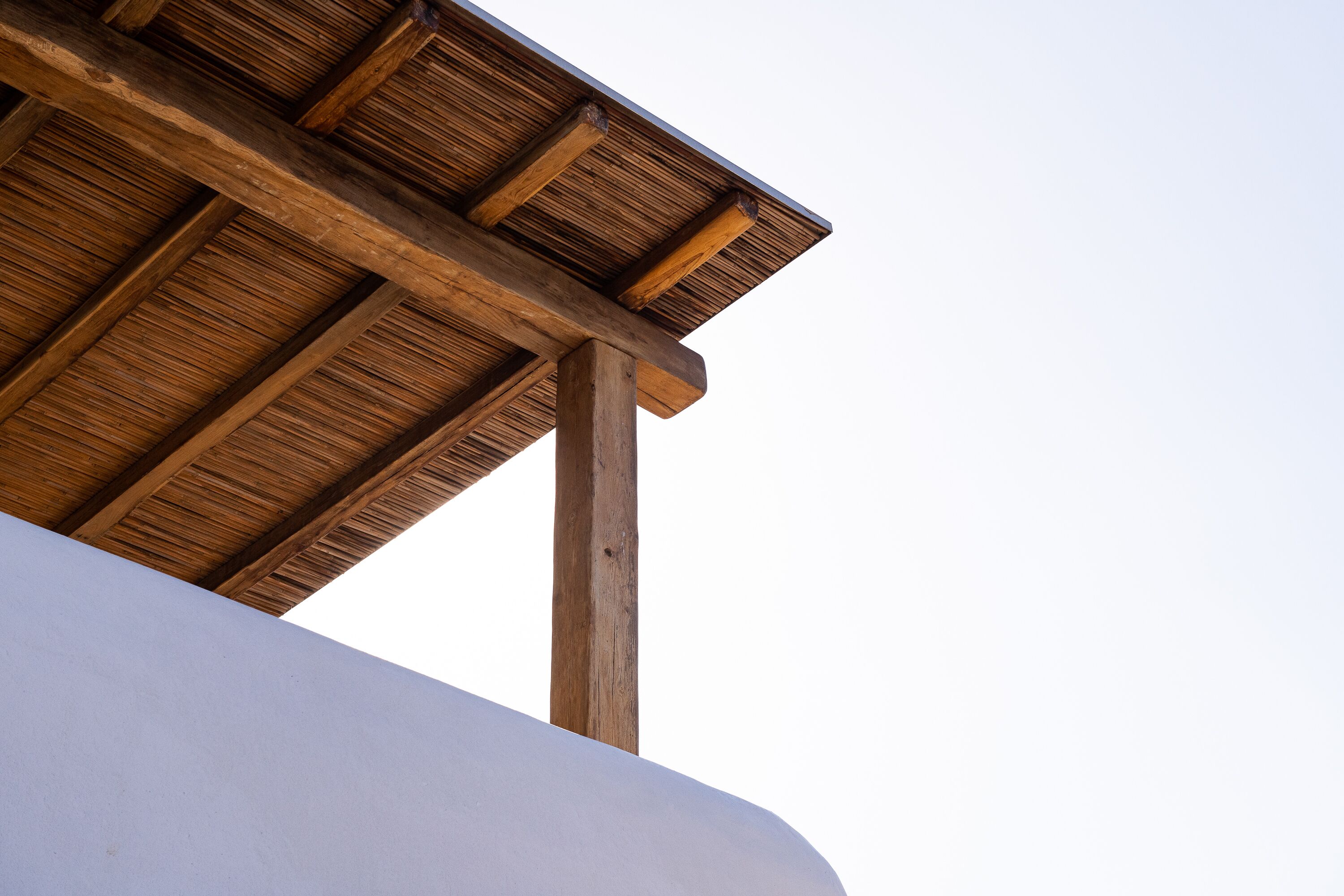 A wooden structure with a slanted roof, likely part of a building's architecture.