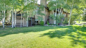 A two-story house with a covered porch and a fenced yard. - Avon Duplex Between Beaver Creek & Vail Resorts! (Avon)