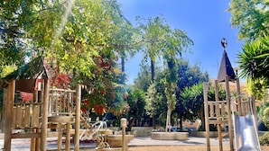 A playground with a slide, climbing structures, and a sandpit. - San Francisco Home II by Gloove (Alicante / Alacant)