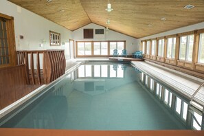 A large indoor swimming pool with wooden railings, large windows, and a high ceiling. - Rita's Retreat: The Bachelor ~ Indoor Saltwater Pool ~ with Lake View! (Sydney)