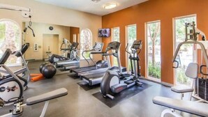 A gym with treadmills, elliptical machines, and free weights. - Sky Luxury 2BDRM Suite | Deluxe Living Cali (Valencia)