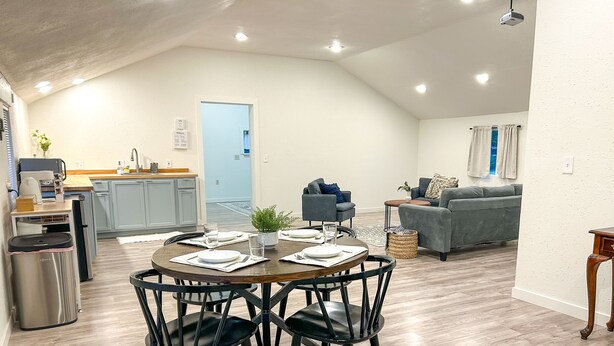 A modern apartment with a dining area, kitchen, and living space. - The Modern Cottage in Rural Lake Stevens (Lake Stevens)