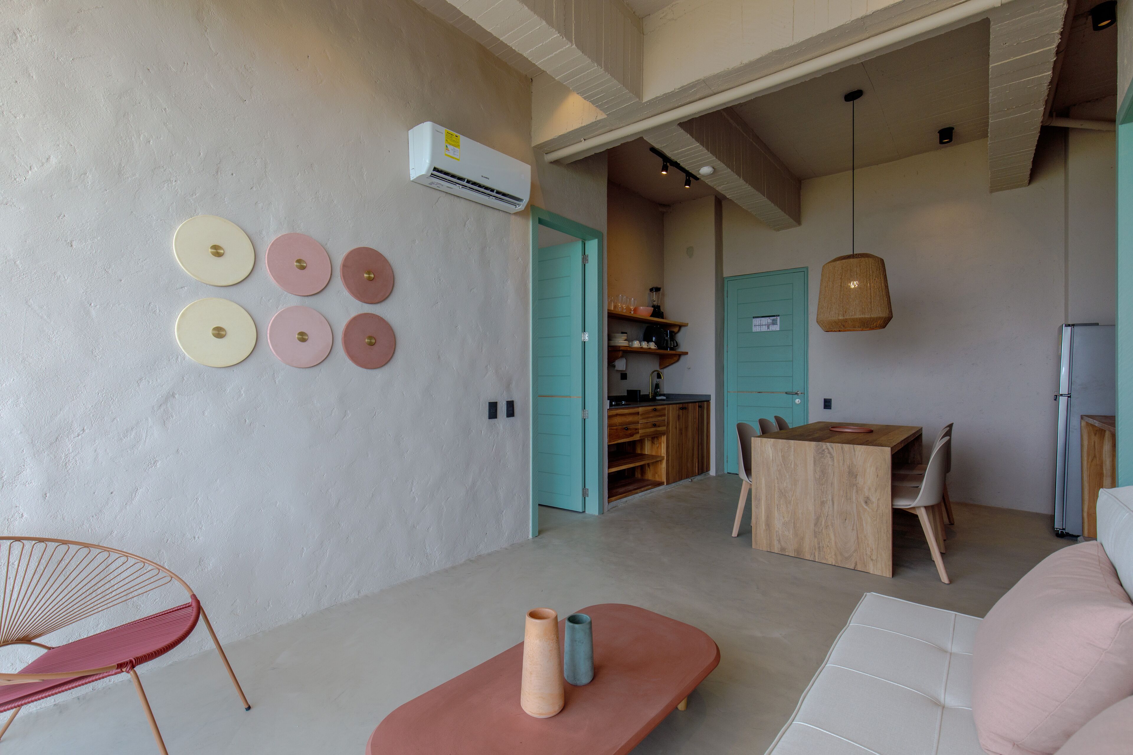 A modern interior with a dining area, kitchen, and seating space.
