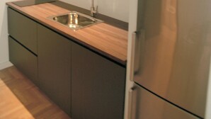 A modern kitchen with a stainless steel refrigerator, a wooden countertop, and a built-in sink. - Citybreak Apartments 301 in Athens, Greece (Athens)